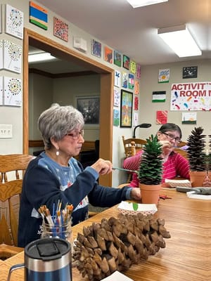 Residents participating in a craft activity indoors