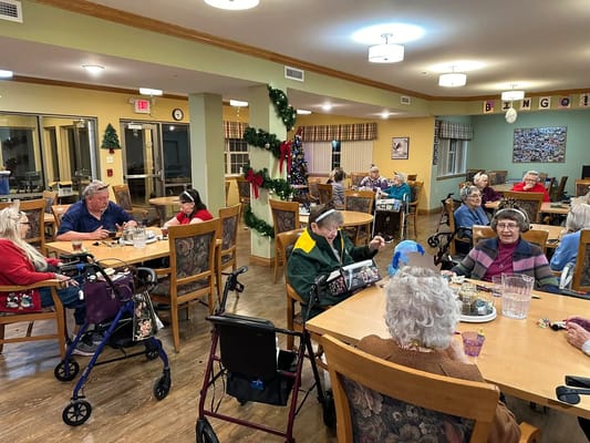 Residents enjoying bingo in a well-lit dining area