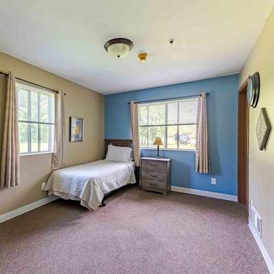 Cozy resident room with a bed and windows