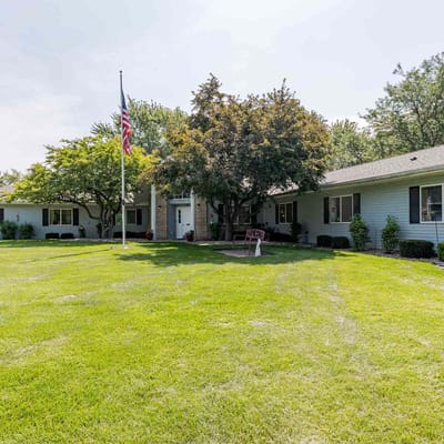 Exterior view of a nursing home with well-maintained lawn