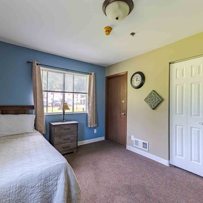 A private resident room with bed and furnishings