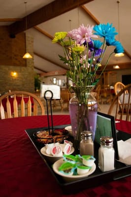 Table setting with flowers and condiments in a dining area