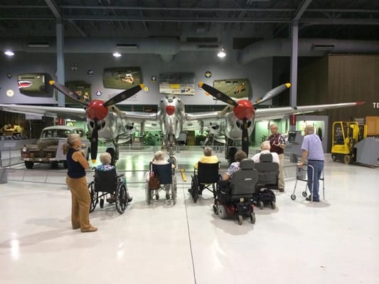 Seniors enjoying an aviation museum visit in wheelchairs