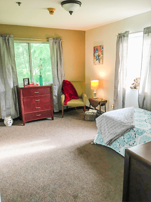 A private resident room with a cozy seating area