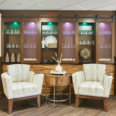 Cozy lounge area with chairs and decorative cabinet