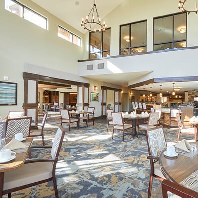 Bright dining room with tables set for meals