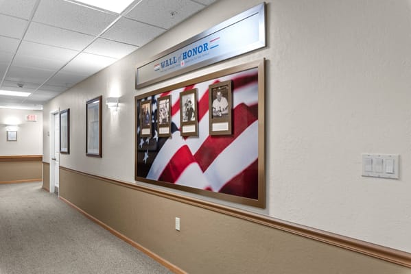 Hallway featuring a tribute wall with photographs