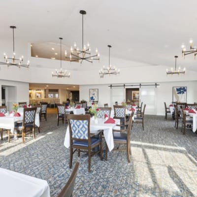 Bright dining room with tables set for a meal