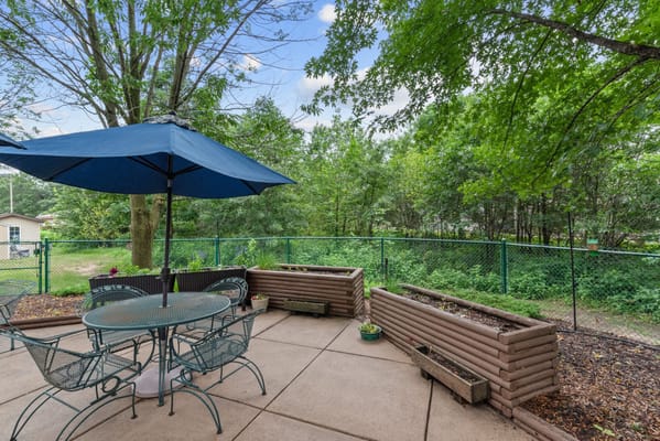 Outdoor patio area with seating and a view of nature