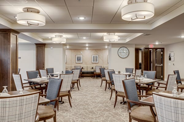 Bright dining room with tables set for a meal