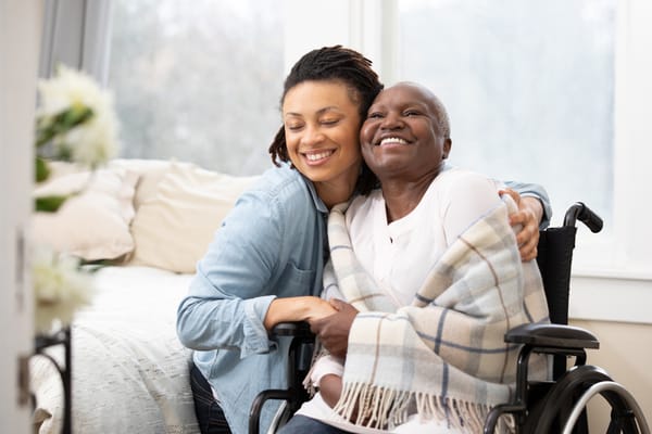 Staff member embracing a resident in a cozy room
