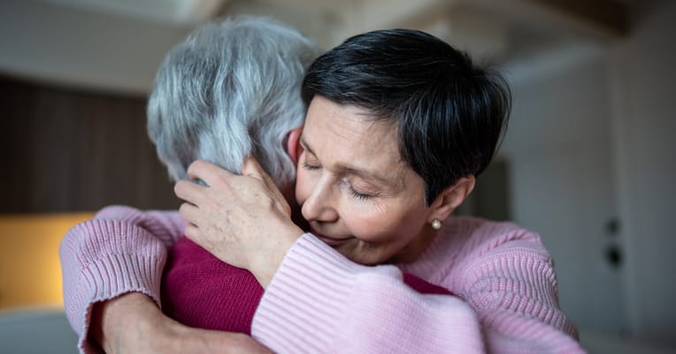Two residents embracing in a warm interaction