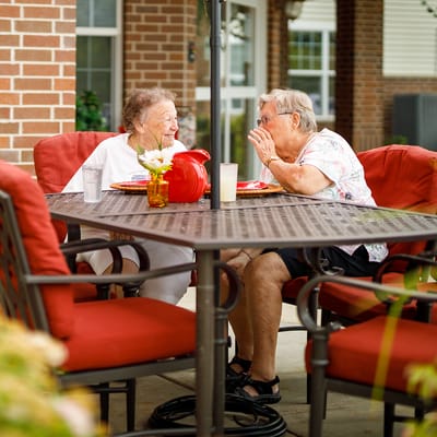 Residents enjoying conversation in an outdoor seating area