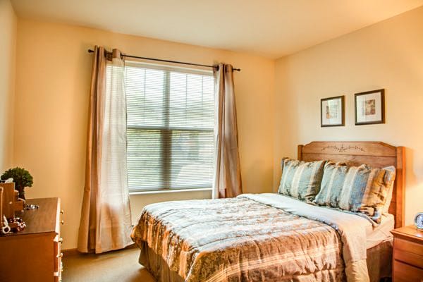 A cozy bedroom with a bed and natural light