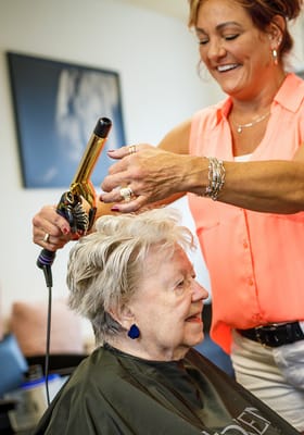 Resident receiving a hairstyle in the salon
