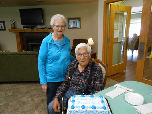 Residents celebrating with a birthday cake in the common area