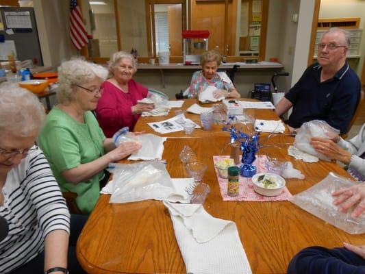 Residents engaged in an activity around a table