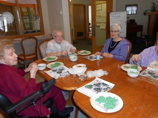 Residents engaged in an arts and crafts activity at a dining table