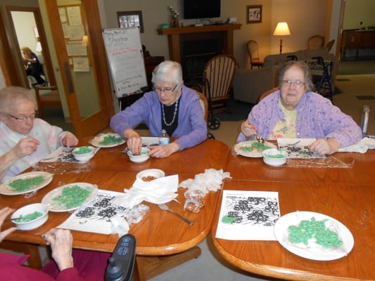 Residents engaged in a holiday cookie decorating activity