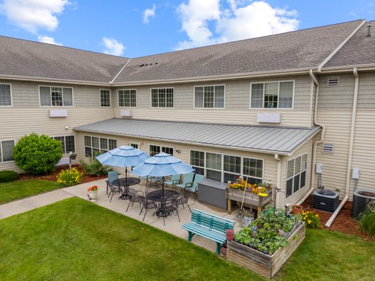 Outdoor seating area with umbrellas and gardens