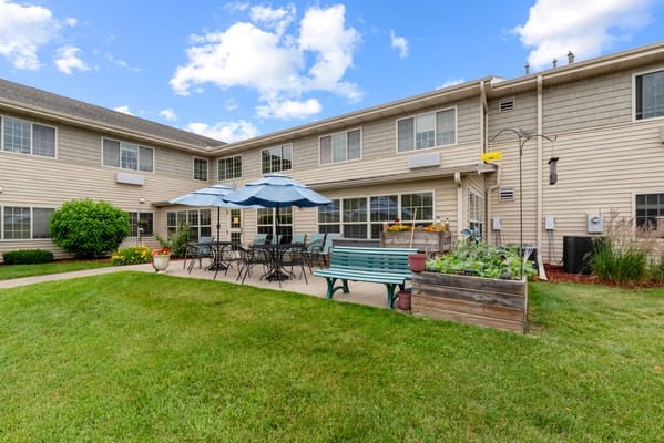 Outdoor seating area with umbrellas and greenery