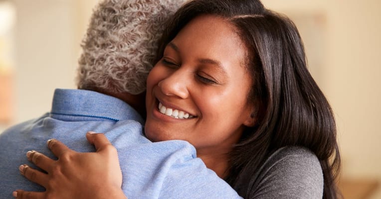 Two residents embracing in a warm, friendly environment