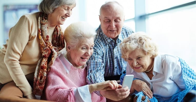 Seniors engaging with a smartphone together