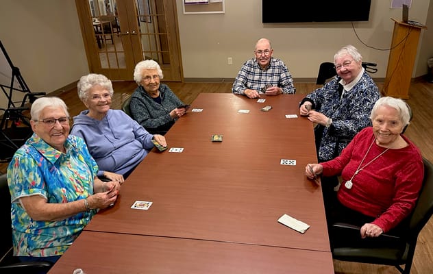Residents playing cards in a common area