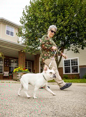 Resident walking a dog outside the facility