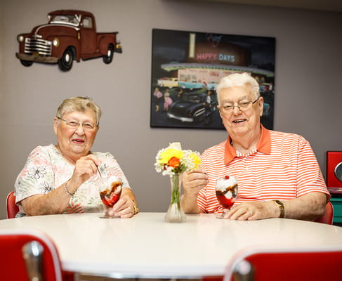 Residents enjoying ice cream sundaes in a common area