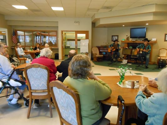 Residents enjoying live music in a common area