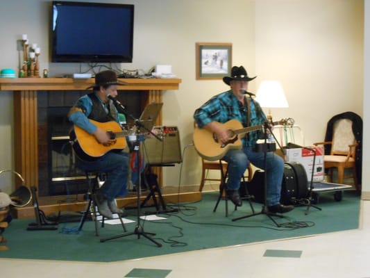 Two musicians performing in a common area