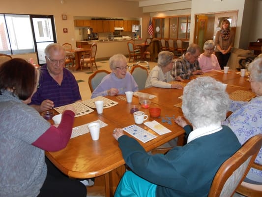 Residents enjoying a bingo game in a common area