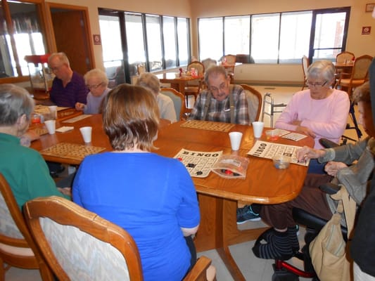 Residents engaging in a bingo game in a common area