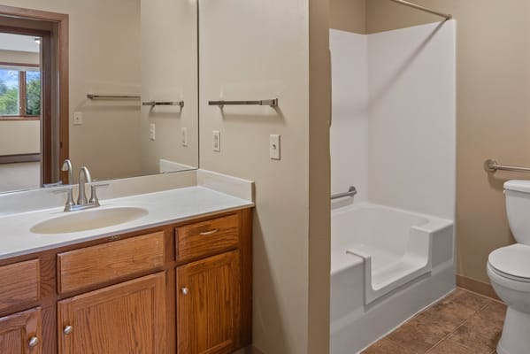 Private bathroom with accessible features and sink area