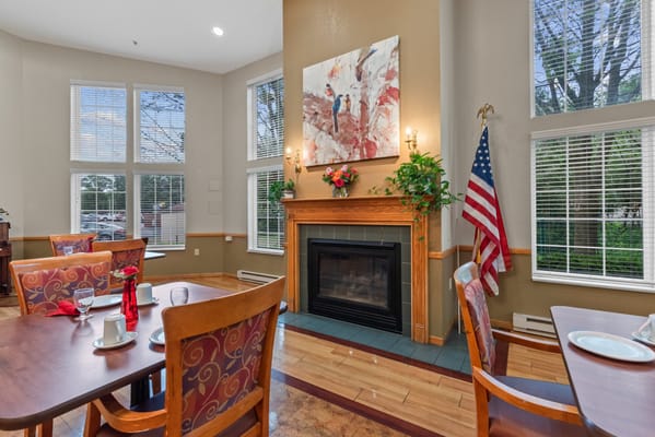 Cozy dining area with wooden tables and fireplace