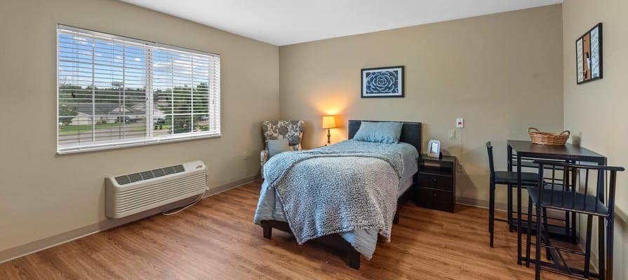 Private resident room with a bed and window