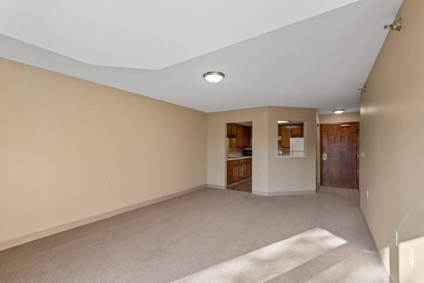 Spacious interior of a resident suite with kitchen view
