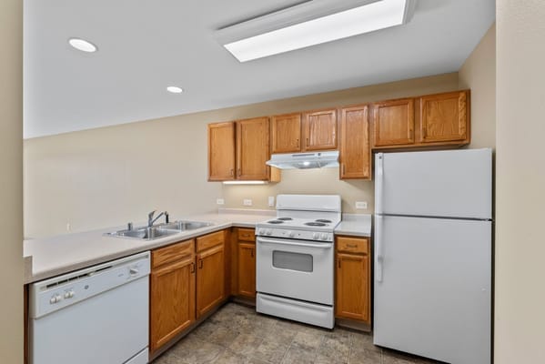 Bright kitchen area with appliances and cabinets