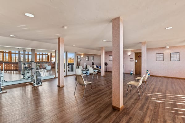 Bright common area with exercise equipment and seating