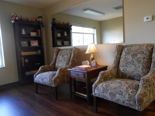 Cozy seating area with armchairs and decorative shelves