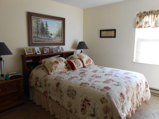 Cozy resident bedroom with a floral quilt