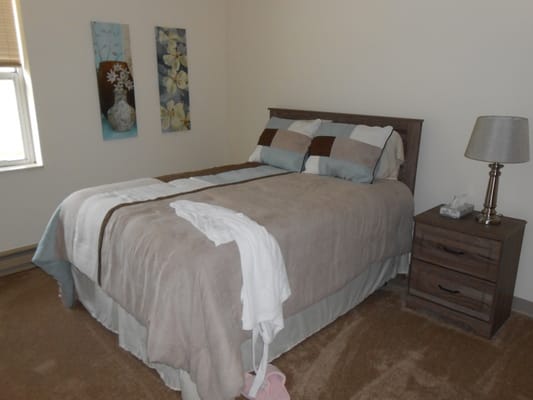 Cozy bedroom with soft bedding and artwork