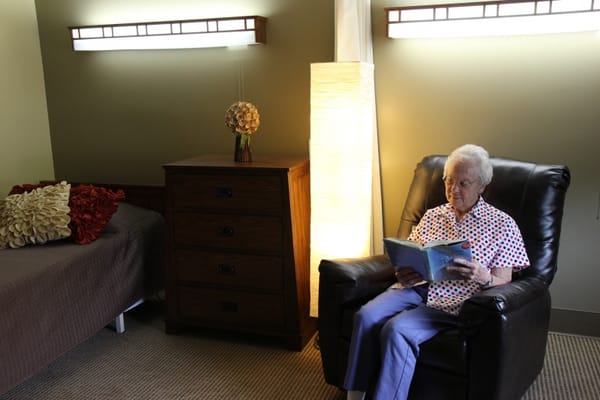 A resident reading in a cozy private room