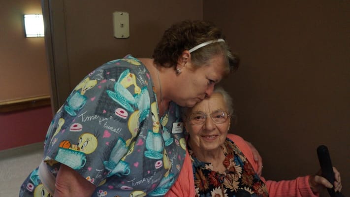 Staff member interacting lovingly with a resident