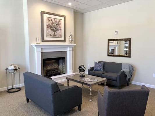 A cozy common area with seating and a fireplace