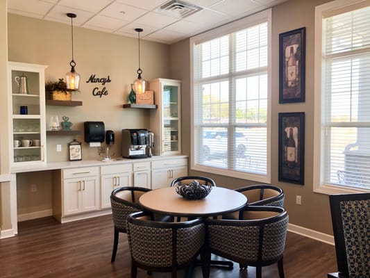 Bright common area with a cafe table and coffee station