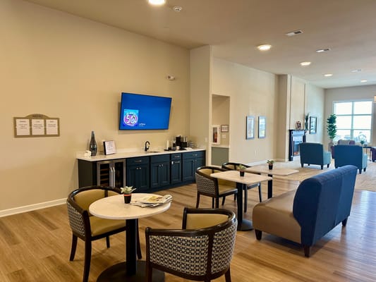 Common area with seating and a TV in the background