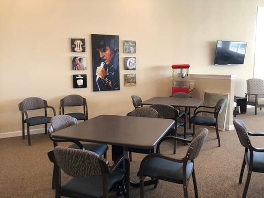 Common area with chairs and a TV