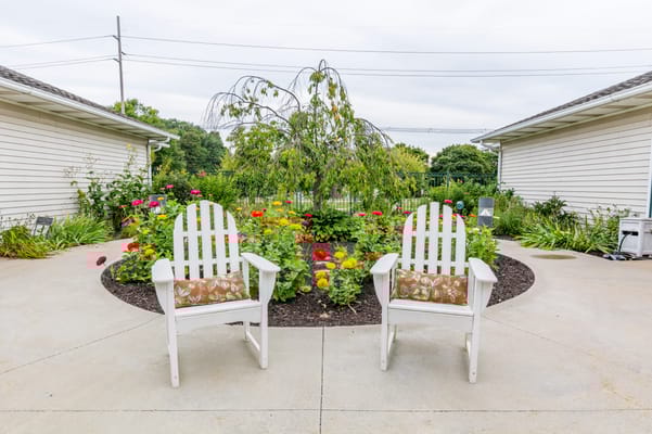 Outdoor seating area with colorful flowers